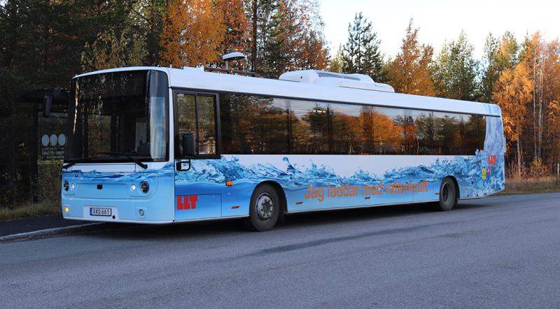 Elbussen är vit med bilden av en fors längs sidan. På taket finns en laddare.